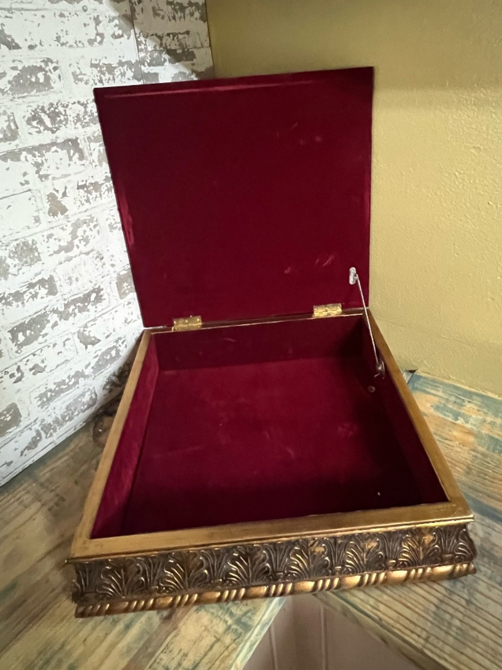 Vintage style wooden box with a carved, gilt finish exterior & deep red velvet